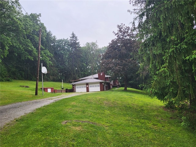 118 Wide View Ter, Unity Twp, PA 15650 - view of side of home with driveway, a lawn, an attached garage, and a chimney