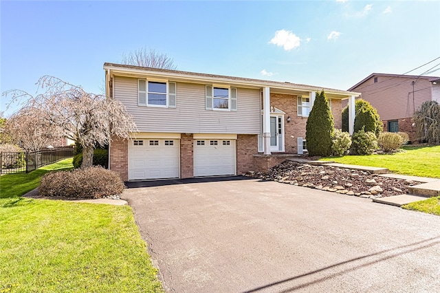 118 Cortland Dr, Hempfield Twp Wml, PA 15672 - raised ranch featuring driveway, brick siding, and an attached garage