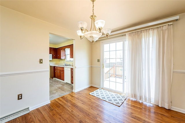 118 Cortland Dr, Hempfield Twp Wml, PA 15672 - unfurnished dining area featuring light wood-type flooring, a chandelier, baseboards, and a sink
