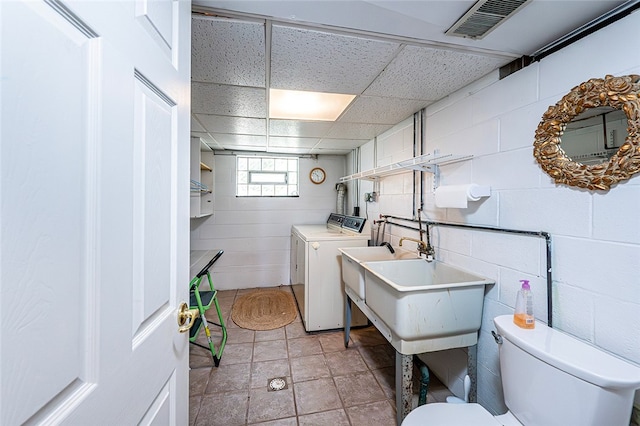 118 Cortland Dr, Hempfield Twp Wml, PA 15672 - bathroom featuring toilet, a drop ceiling, concrete block wall, and washer and clothes dryer