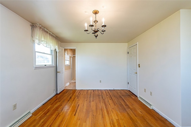 118 Cortland Dr, Hempfield Twp Wml, PA 15672 - empty room with baseboard heating, a chandelier, light wood finished floors, and baseboards