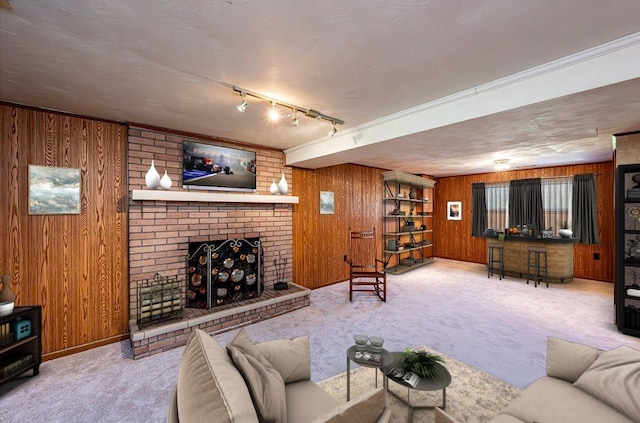118 Cortland Dr, Hempfield Twp Wml, PA 15672 - carpeted living area featuring wood walls, a brick fireplace, and baseboards