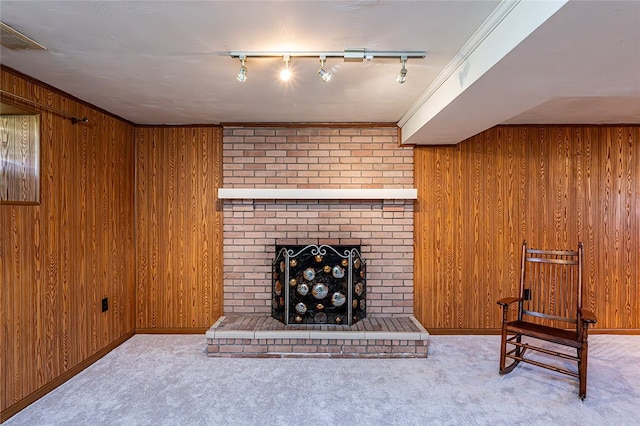 118 Cortland Dr, Hempfield Twp Wml, PA 15672 - unfurnished living room with a brick fireplace, wooden walls, carpet flooring, track lighting, and baseboards