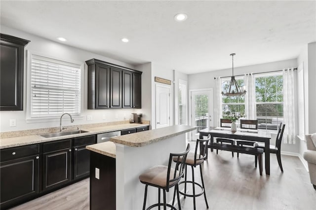 215 Old Hickory Rd, Jackson Twp But, PA 16063 - kitchen with a sink, light wood-style floors, light countertops, a breakfast bar area, and a kitchen island