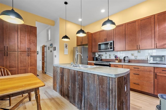 534 Trenton Ave, Regent Square, PA 15221 - kitchen with appliances with stainless steel finishes, a sink, light wood-style flooring, decorative backsplash, and light countertops