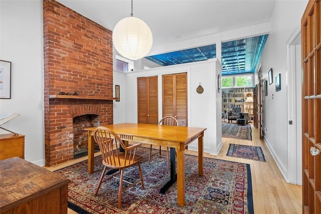 534 Trenton Ave, Regent Square, PA 15221 - dining space with light wood-style flooring, a fireplace, and baseboards
