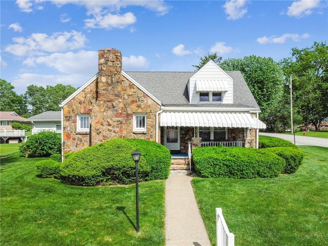 1068 Lakeview Dr, Unity Twp, PA 15650 - view of front of property with a front lawn, stone siding, and a chimney