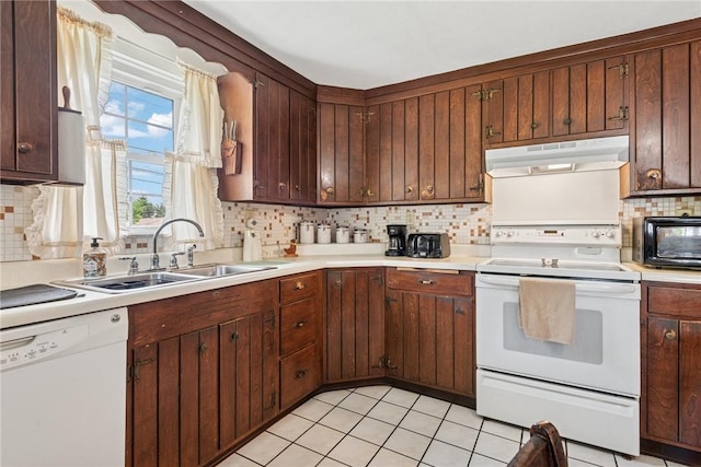 1068 Lakeview Dr, Unity Twp, PA 15650 - kitchen with white appliances, under cabinet range hood, a sink, and light countertops