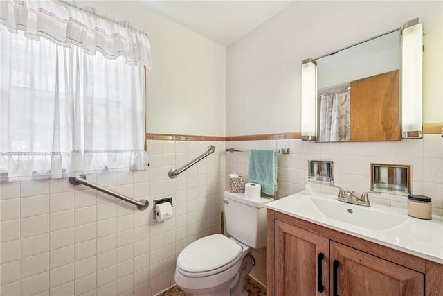 1068 Lakeview Dr, Unity Twp, PA 15650 - bathroom featuring healthy amount of natural light, toilet, vanity, tile walls, and wainscoting