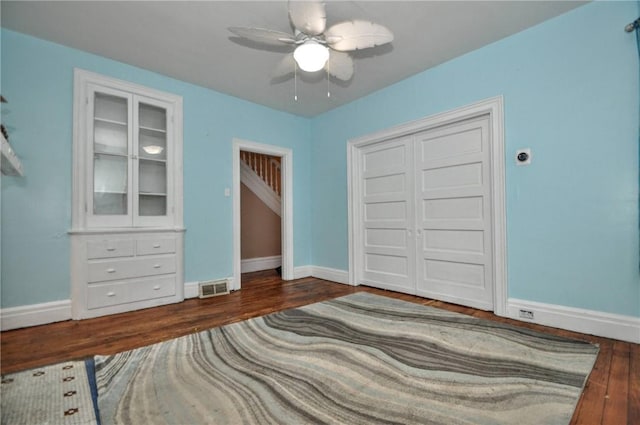 222 Orchard Ave, Canonsburg, PA 15317 - unfurnished bedroom with wood finished floors, baseboards, a ceiling fan, and a closet