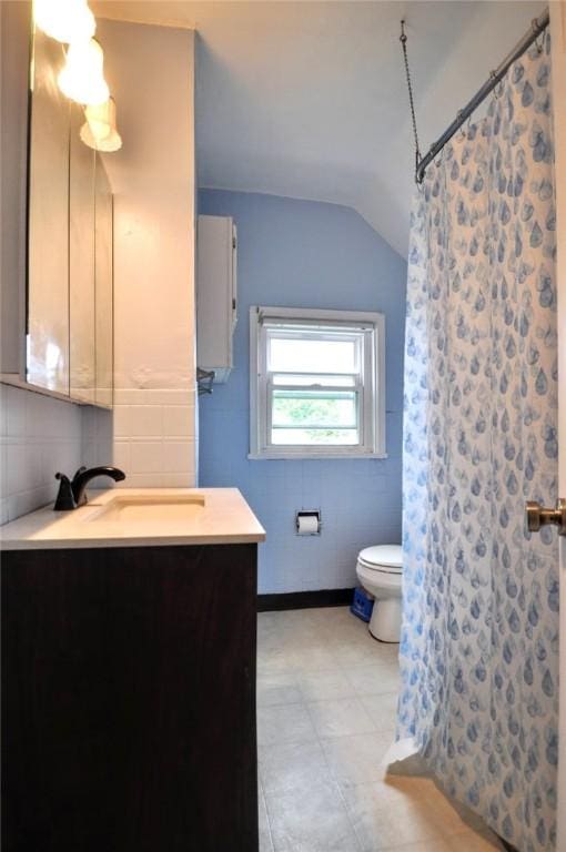 222 Orchard Ave, Canonsburg, PA 15317 - bathroom with lofted ceiling, toilet, vanity, tile walls, and curtained shower