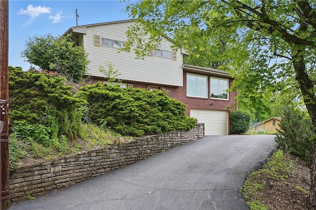 5849 Wilson Dr, Bethel Park, PA 15102 - view of front of house with driveway, a garage, and brick siding