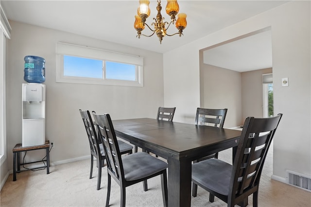 5849 Wilson Dr, Bethel Park, PA 15102 - dining area featuring light carpet, a chandelier, and baseboards