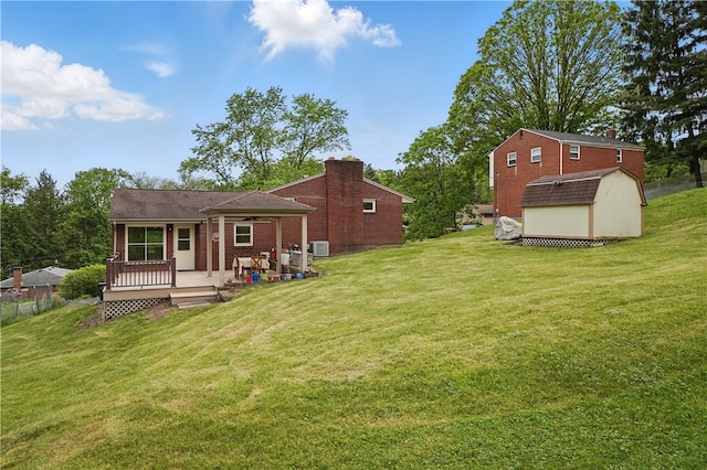 5849 Wilson Dr, Bethel Park, PA 15102 - rear view of property featuring a lawn and brick siding