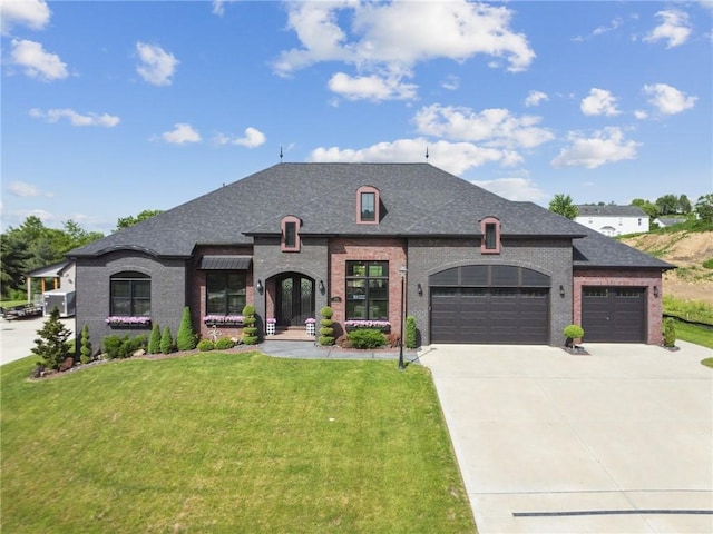 7858 Oscar Ct, North Huntingdon, PA 15642 - french provincial home with an attached garage, brick siding, a front lawn, driveway, and roof with shingles