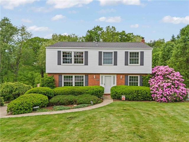 187 Friar Ln, Peters Twp, PA 15317 - colonial home with a chimney, brick siding, and a front yard