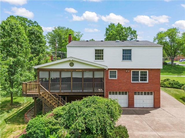 187 Friar Ln, Peters Twp, PA 15317 - back of property featuring a garage, brick siding, concrete driveway, stairway, and a chimney