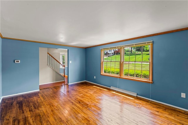 187 Friar Ln, Peters Twp, PA 15317 - unfurnished room with baseboard heating, crown molding, wood finished floors, baseboards, and stairway