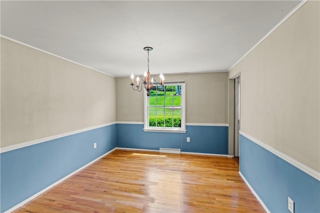 187 Friar Ln, Peters Twp, PA 15317 - unfurnished room featuring a chandelier, wood finished floors, crown molding, and baseboards