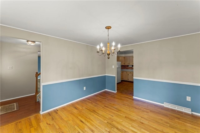 187 Friar Ln, Peters Twp, PA 15317 - unfurnished room with a chandelier, wood finished floors, ornamental molding, and baseboards