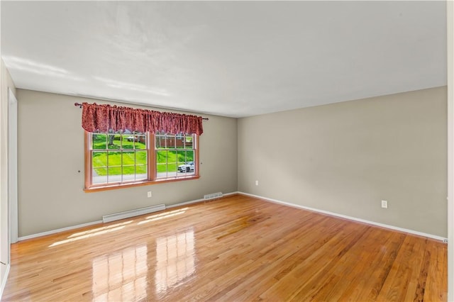 187 Friar Ln, Peters Twp, PA 15317 - unfurnished room with a baseboard heating unit, wood finished floors, and baseboards