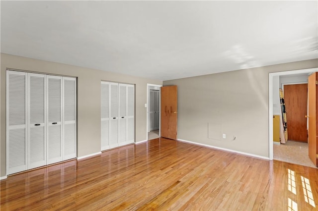 187 Friar Ln, Peters Twp, PA 15317 - unfurnished bedroom featuring light wood-type flooring, multiple closets, and baseboards