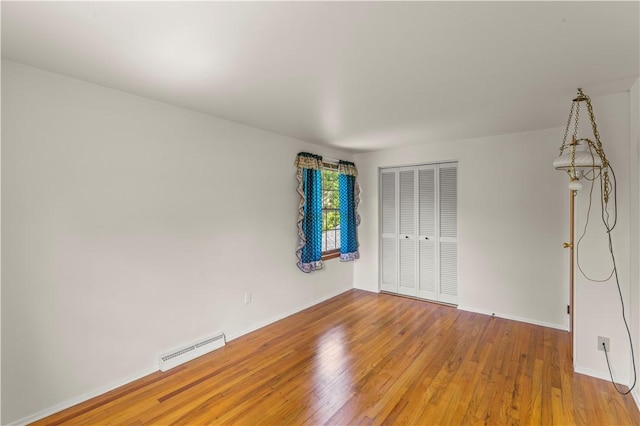 187 Friar Ln, Peters Twp, PA 15317 - unfurnished bedroom featuring wood finished floors, a closet, and baseboards