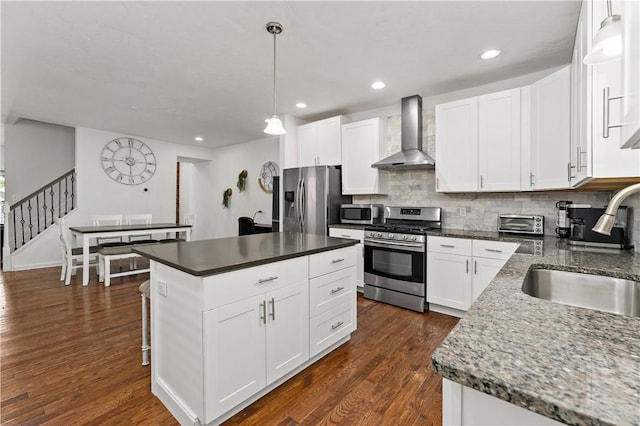 239 Albert St, Mt Washington, PA 15211 - kitchen featuring wall chimney exhaust hood, appliances with stainless steel finishes, a sink, backsplash, and dark wood-style floors
