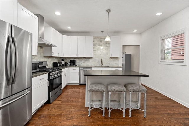 239 Albert St, Mt Washington, PA 15211 - kitchen with stainless steel appliances, wall chimney range hood, a sink, dark countertops, and a breakfast bar