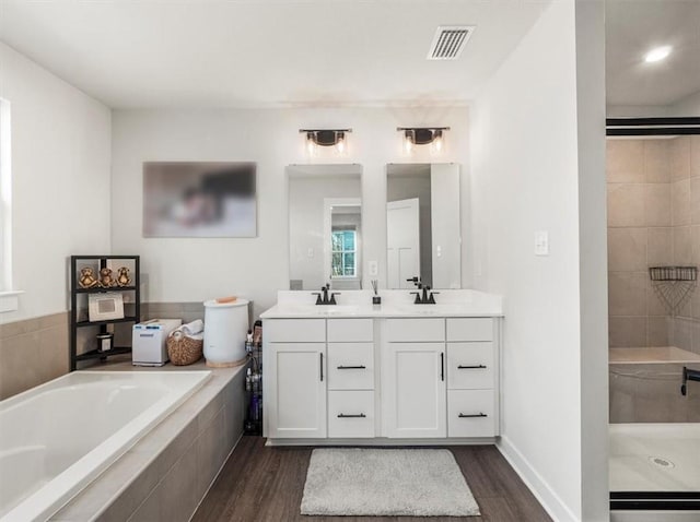 127 Red Horse Dr, Buffalo Twp, PA 16055 - full bathroom featuring wood finished floors, a bath, double vanity, and a tile shower