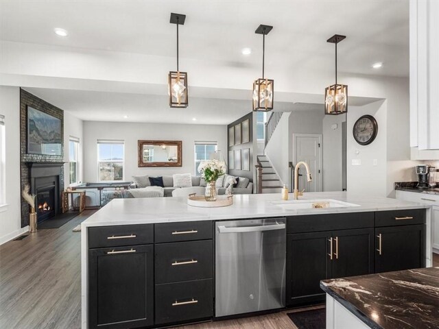 127 Red Horse Dr, Buffalo Twp, PA 16055 - kitchen featuring dishwasher, a sink, open floor plan, wood finished floors, and a fireplace