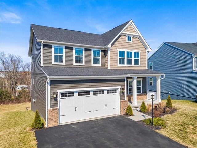 127 Red Horse Dr, Buffalo Twp, PA 16055 - view of front of house with brick siding, a front lawn, driveway, an attached garage, and a porch