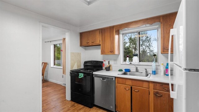 4817 E Willock Rd, Baldwin Boro, PA 15227 - kitchen with freestanding refrigerator, black electric range, stainless steel dishwasher, a sink, and light countertops