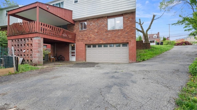 4817 E Willock Rd, Baldwin Boro, PA 15227 - rear view of house with driveway, a garage, and brick siding