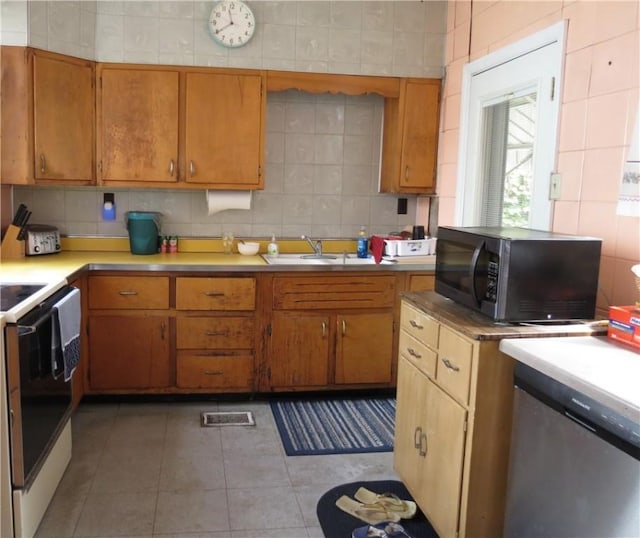 2317 Sidney St, South Side, PA 15203 - kitchen featuring dishwasher, black microwave, white electric range oven, a sink, and light countertops