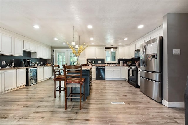 415 Governor Dr, Shaler, PA 15101 - kitchen with black appliances, wine cooler, a sink, white cabinets, and recessed lighting