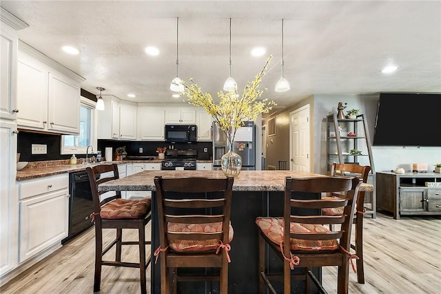 415 Governor Dr, Shaler, PA 15101 - kitchen featuring black appliances, light wood finished floors, white cabinetry, a kitchen island, and recessed lighting