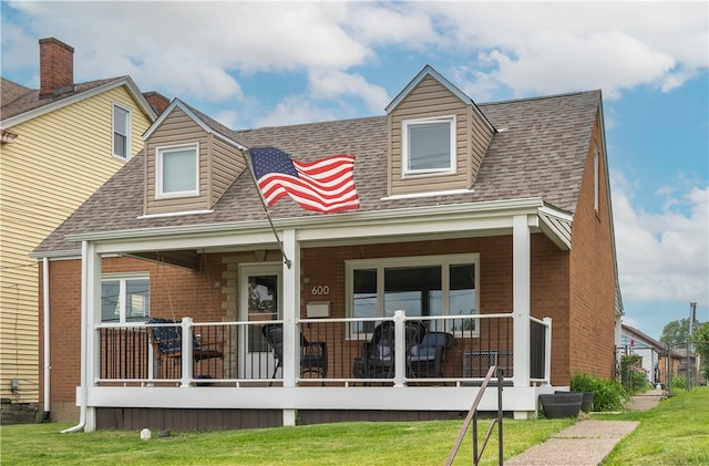 600 Margaret St, Mount Oliver, PA 15210 - back of house with brick siding, roof with shingles, a porch, and a lawn