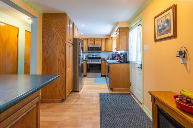 600 Margaret St, Mount Oliver, PA 15210 - kitchen featuring appliances with stainless steel finishes, a sink, brown cabinetry, light wood-style flooring, and dark countertops