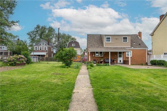 600 Margaret St, Mount Oliver, PA 15210 - view of front of house featuring roof with shingles, brick siding, and a patio
