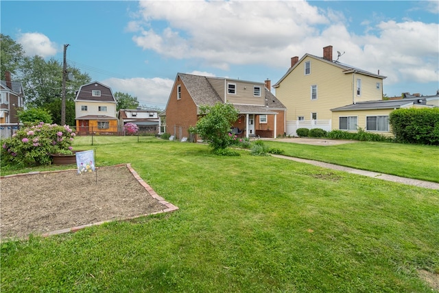 600 Margaret St, Mount Oliver, PA 15210 - back of property with brick siding, a garden, and a chimney