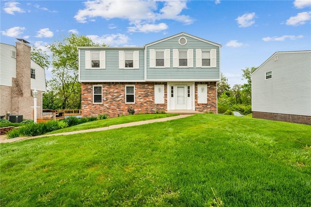 1056 Mcallister Dr, Plum Boro, PA 15068 - view of front facade featuring brick siding, a front lawn, and central AC