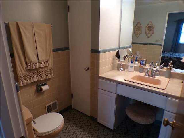 1235 Old Concord Rd, Monroeville, PA 15146 - bathroom featuring tile walls, a wainscoted wall, toilet, and vanity