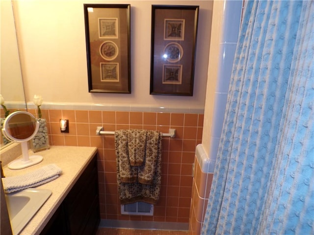 1235 Old Concord Rd, Monroeville, PA 15146 - bathroom with curtained shower, vanity, a wainscoted wall, and tile walls
