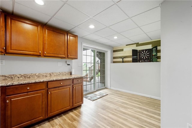 97 Clover Ln, Pine Twp Nal, PA 15044 - kitchen featuring light wood-style flooring, light stone countertops, brown cabinets, recessed lighting, and a paneled ceiling