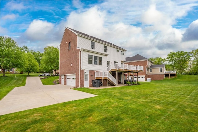 97 Clover Ln, Pine Twp Nal, PA 15044 - rear view of house featuring brick siding, a garage, stairway, a wooden deck, and concrete driveway