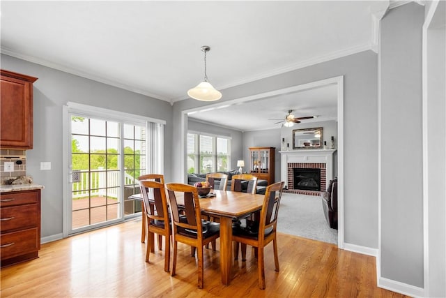 97 Clover Ln, Pine Twp Nal, PA 15044 - dining room with a brick fireplace, ornamental molding, ceiling fan, light wood-type flooring, and baseboards