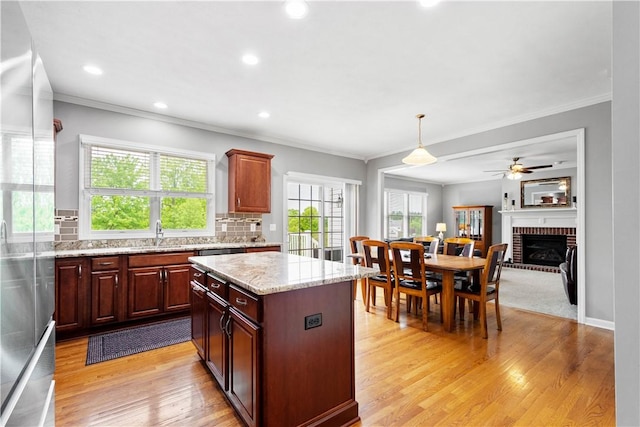 97 Clover Ln, Pine Twp Nal, PA 15044 - kitchen with ornamental molding, stainless steel refrigerator, tasteful backsplash, ceiling fan, and light wood finished floors