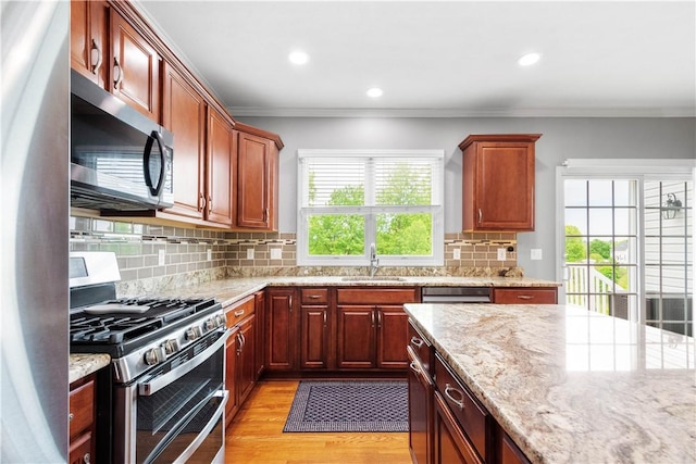 97 Clover Ln, Pine Twp Nal, PA 15044 - kitchen with stainless steel appliances, a sink, light wood finished floors, crown molding, and light stone countertops