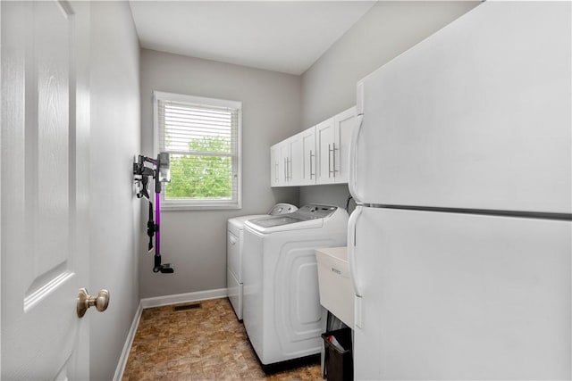 97 Clover Ln, Pine Twp Nal, PA 15044 - laundry area featuring washing machine and clothes dryer, cabinet space, and baseboards